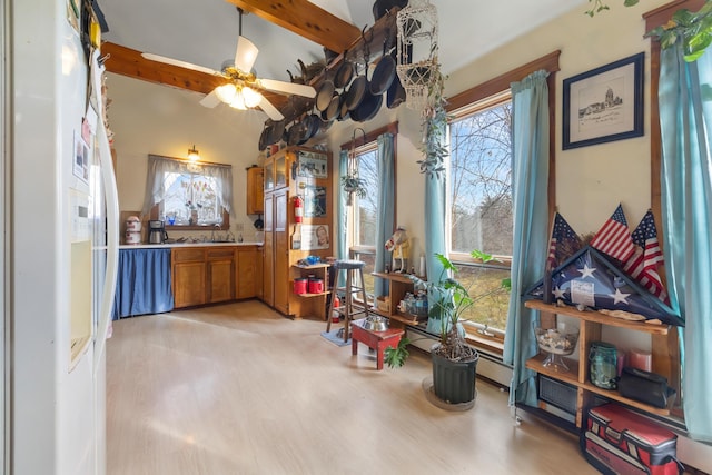 misc room with light wood-type flooring, lofted ceiling with beams, and ceiling fan