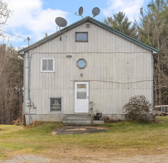 rear view of property featuring a yard