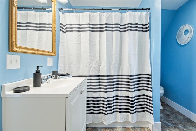 bathroom featuring vanity, toilet, and a shower with shower curtain