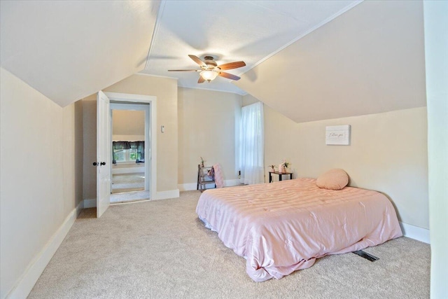 bedroom featuring vaulted ceiling, light carpet, and ceiling fan