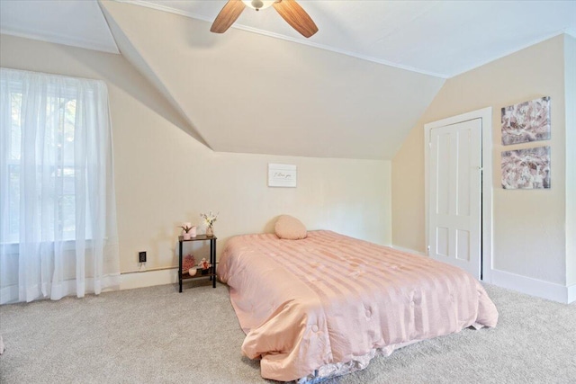 carpeted bedroom with ceiling fan and vaulted ceiling