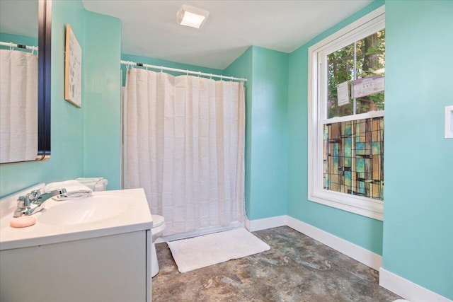 bathroom featuring toilet, concrete floors, a shower with curtain, and vanity