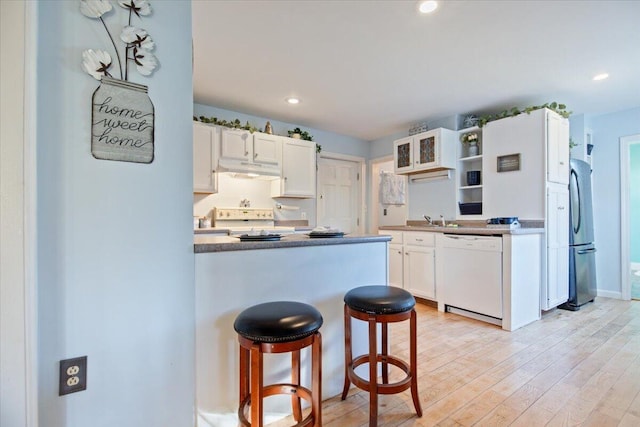 kitchen featuring stainless steel fridge, white cabinetry, stove, light wood-type flooring, and dishwasher