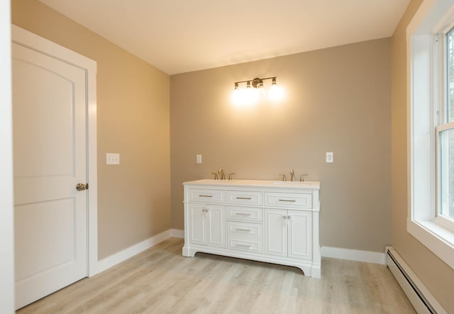 bathroom with vanity, wood-type flooring, and a baseboard radiator