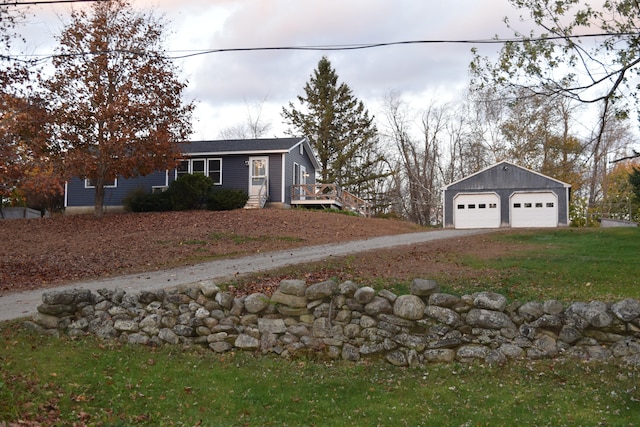 view of yard with a garage and an outbuilding