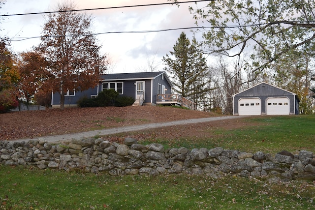 view of front facade featuring a garage and an outbuilding