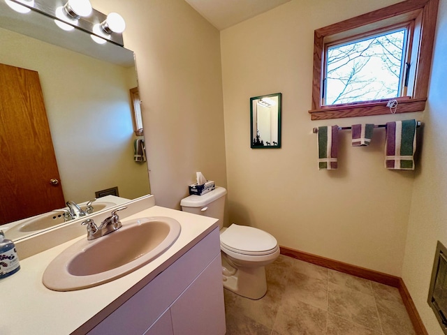 6071 Village On The Green Rd Unit G-11, Carrabassett Valley, ME 04947 - half bathroom featuring toilet, baseboards, and vanity