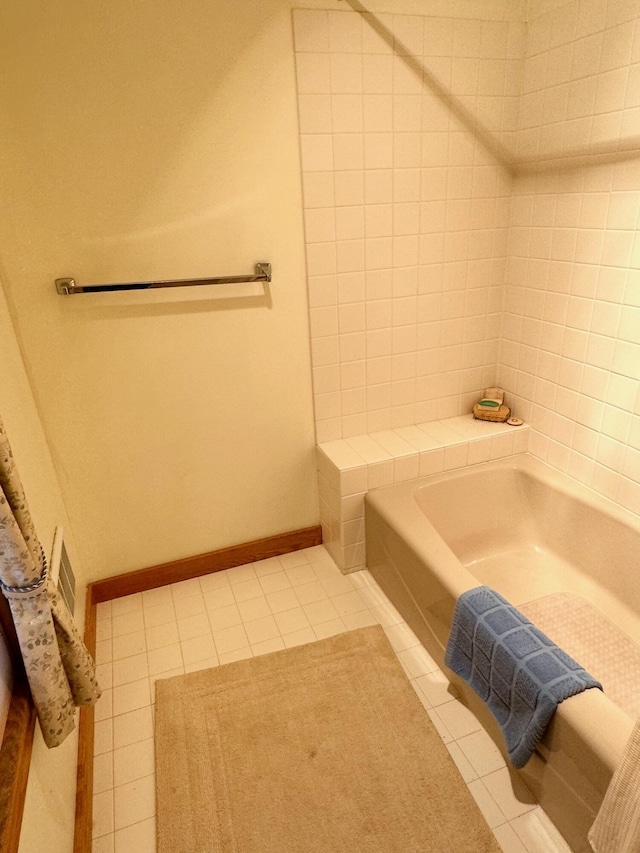 6071 Village On The Green Rd Unit G-11, Carrabassett Valley, ME 04947 - bathroom featuring tile patterned flooring, a tub to relax in, and baseboards