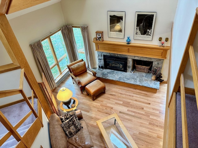 6071 Village On The Green Rd Unit G-11, Carrabassett Valley, ME 04947 - living room with wood finished floors and a stone fireplace