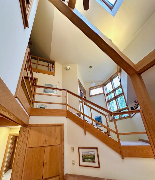 6071 Village On The Green Rd Unit G-11, Carrabassett Valley, ME 04947 - staircase with a high ceiling, a skylight, and ceiling fan