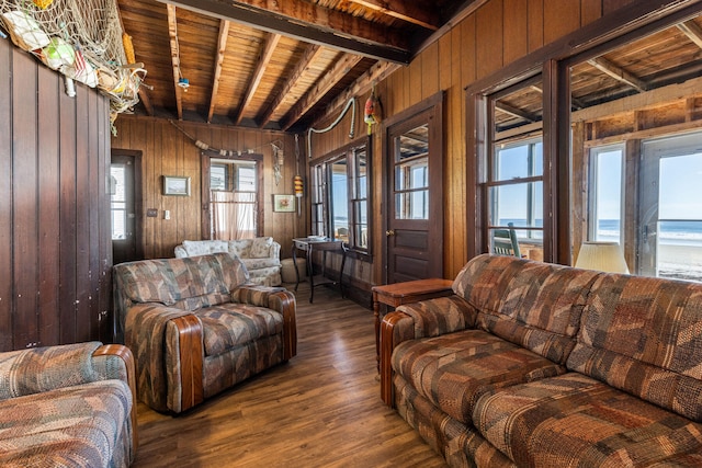 living room featuring beamed ceiling, wooden walls, wood ceiling, and hardwood / wood-style flooring