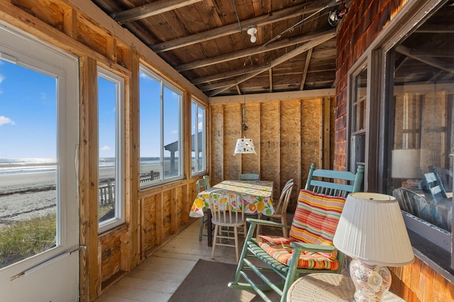 sunroom / solarium featuring lofted ceiling with beams, wood ceiling, a water view, and plenty of natural light