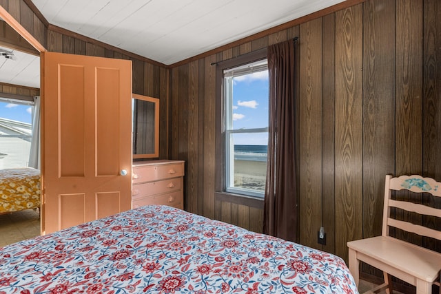 bedroom featuring wood walls, wooden ceiling, a water view, and vaulted ceiling