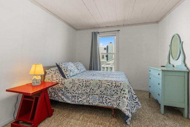 carpeted bedroom with crown molding and wooden ceiling