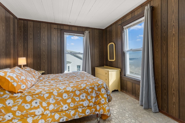 bedroom featuring wood walls