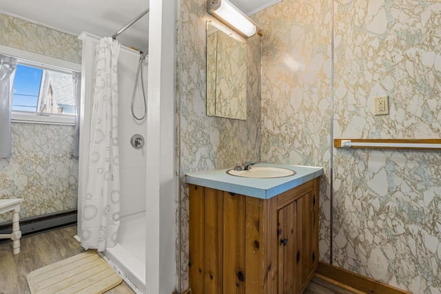 229 Atlantic Ave, Wells, ME 04090 - full bath featuring wood finished floors, vanity, a shower with shower curtain, wallpapered walls, and ornamental molding