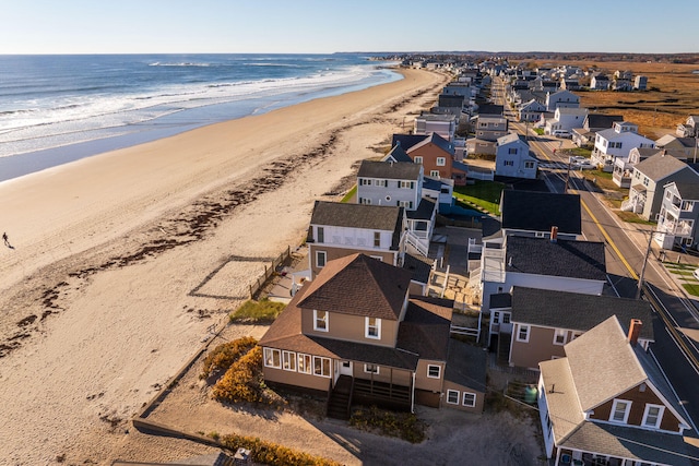 drone / aerial view featuring a water view and a beach view