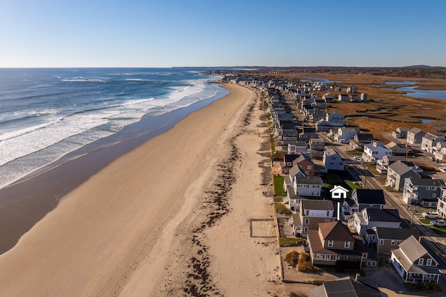 birds eye view of property with a water view and a view of the beach