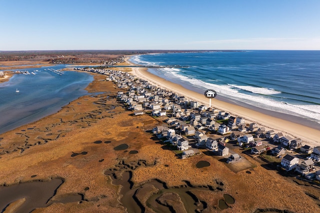 bird's eye view featuring a water view and a beach view