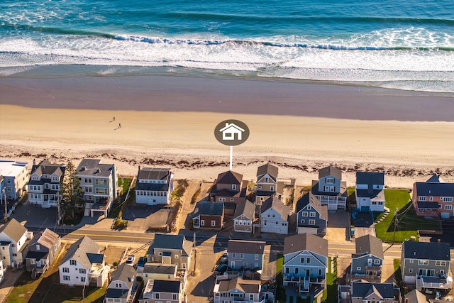 drone / aerial view featuring a water view and a view of the beach