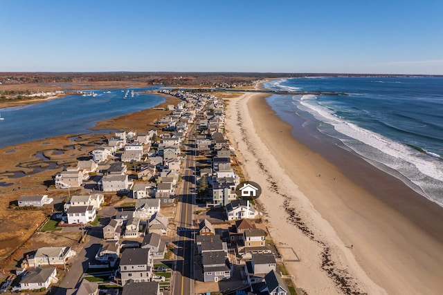 bird's eye view featuring a water view and a beach view