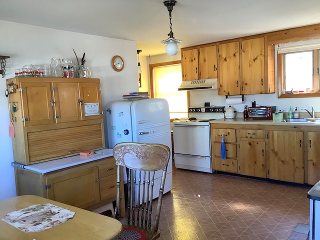 kitchen with sink, electric range, and decorative light fixtures