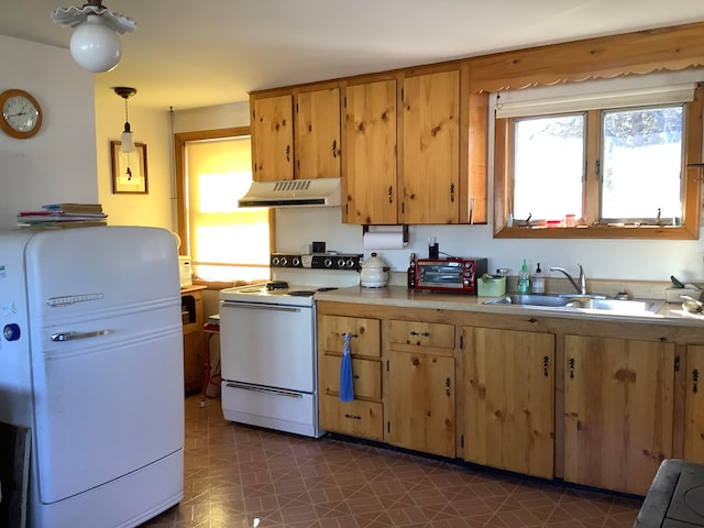 kitchen with white electric range, decorative light fixtures, sink, and tile patterned floors