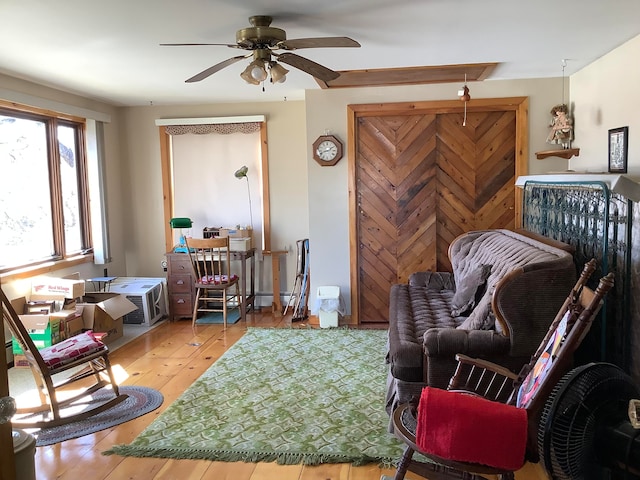 sitting room featuring ceiling fan and hardwood / wood-style flooring