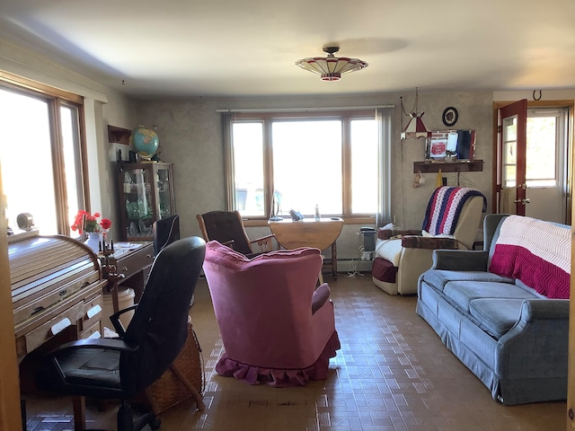 living room featuring a wealth of natural light and a baseboard radiator