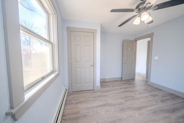 empty room featuring ceiling fan and light hardwood / wood-style flooring