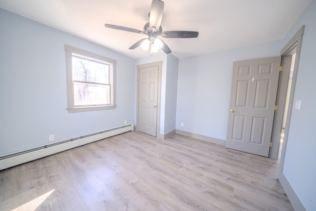 unfurnished bedroom with light hardwood / wood-style floors, baseboard heating, and ceiling fan