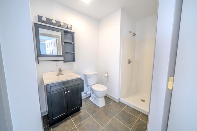 bathroom featuring toilet, walk in shower, vanity, and tile patterned flooring