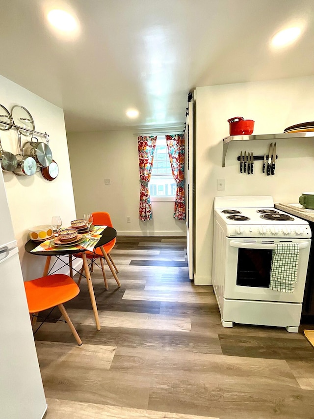 kitchen featuring wood-type flooring and white appliances