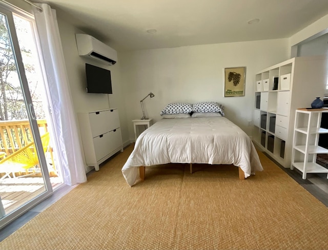 bedroom with access to exterior and an AC wall unit