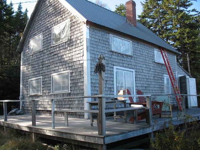 back of house with a deck