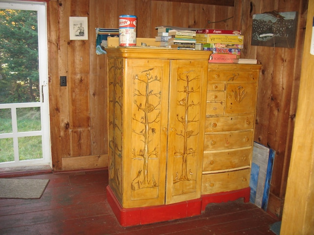 room details featuring wood-type flooring and wood walls