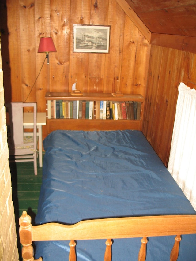 bedroom with wood walls