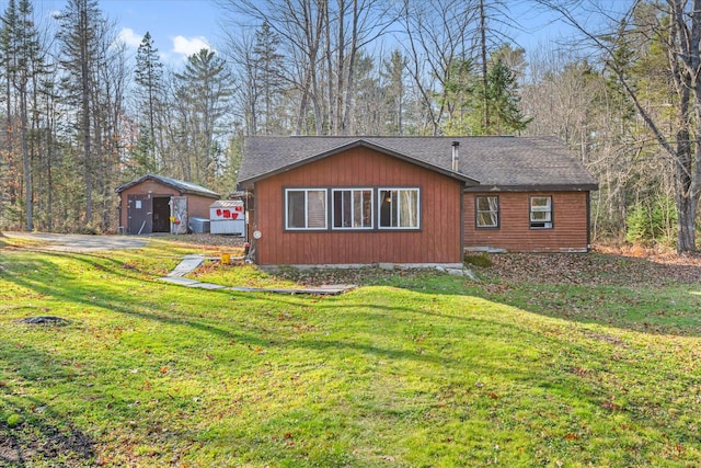 view of side of home with a yard