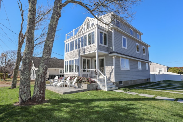 back of property with a patio area, a lawn, and a balcony