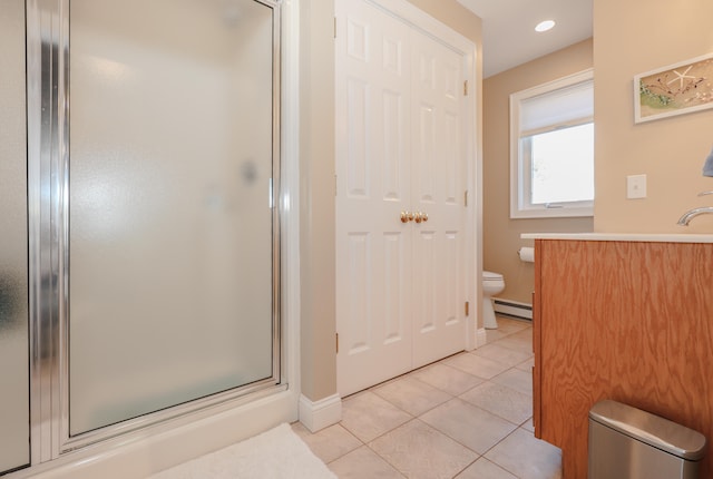 bathroom featuring a shower with door, toilet, tile patterned flooring, baseboard heating, and vanity