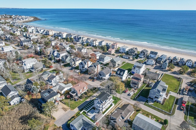 drone / aerial view with a water view and a beach view