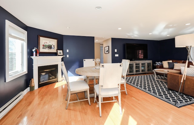 167 S Tibbetts Ave, Wells, ME 04090 - dining room with a baseboard radiator, light wood-style floors, a glass covered fireplace, recessed lighting, and baseboards