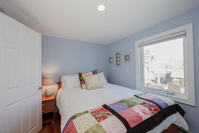 bedroom with dark wood-type flooring