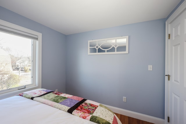 bedroom with dark hardwood / wood-style floors