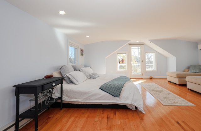 bedroom featuring lofted ceiling and hardwood / wood-style flooring