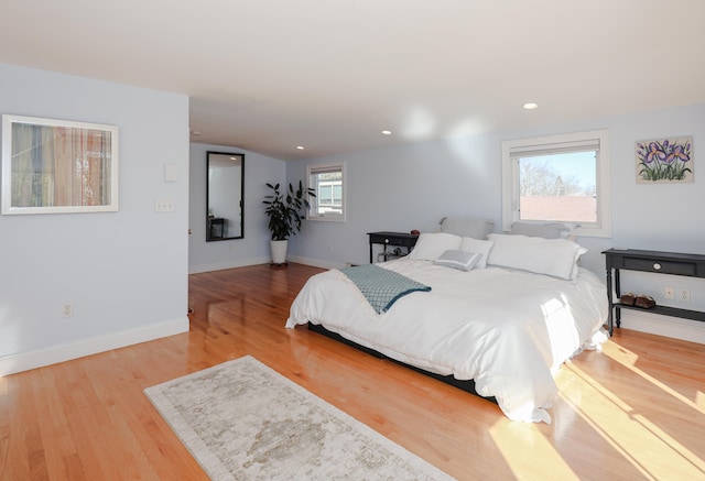 bedroom featuring wood-type flooring and multiple windows