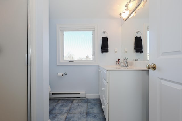 bathroom featuring vanity, toilet, tile patterned floors, and a baseboard radiator