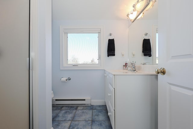 167 S Tibbetts Ave, Wells, ME 04090 - bathroom featuring baseboard heating, vanity, toilet, and baseboards