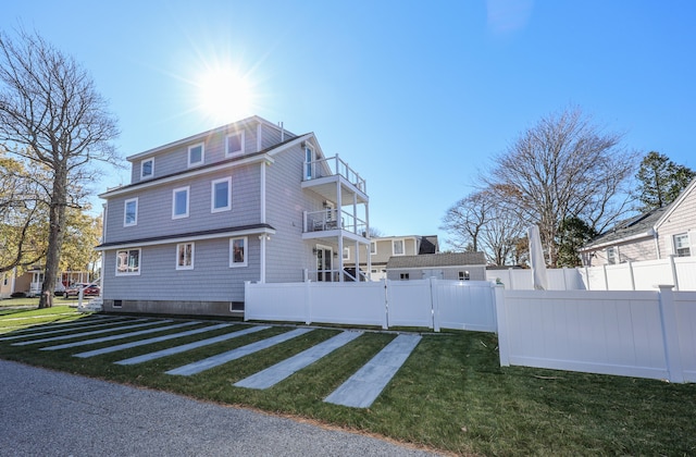 exterior space featuring a yard and a balcony