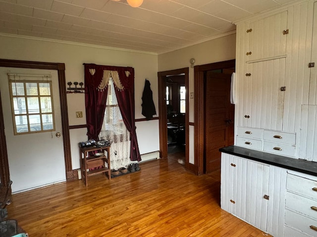 interior space featuring light wood-type flooring and ornamental molding